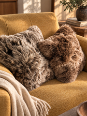 Brown sheepskin pillow on a yellow couch 16x16
