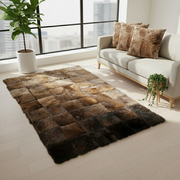 A rectangular patchwork area rug made of various shades of bison hide leather, arranged in a checkered pattern.