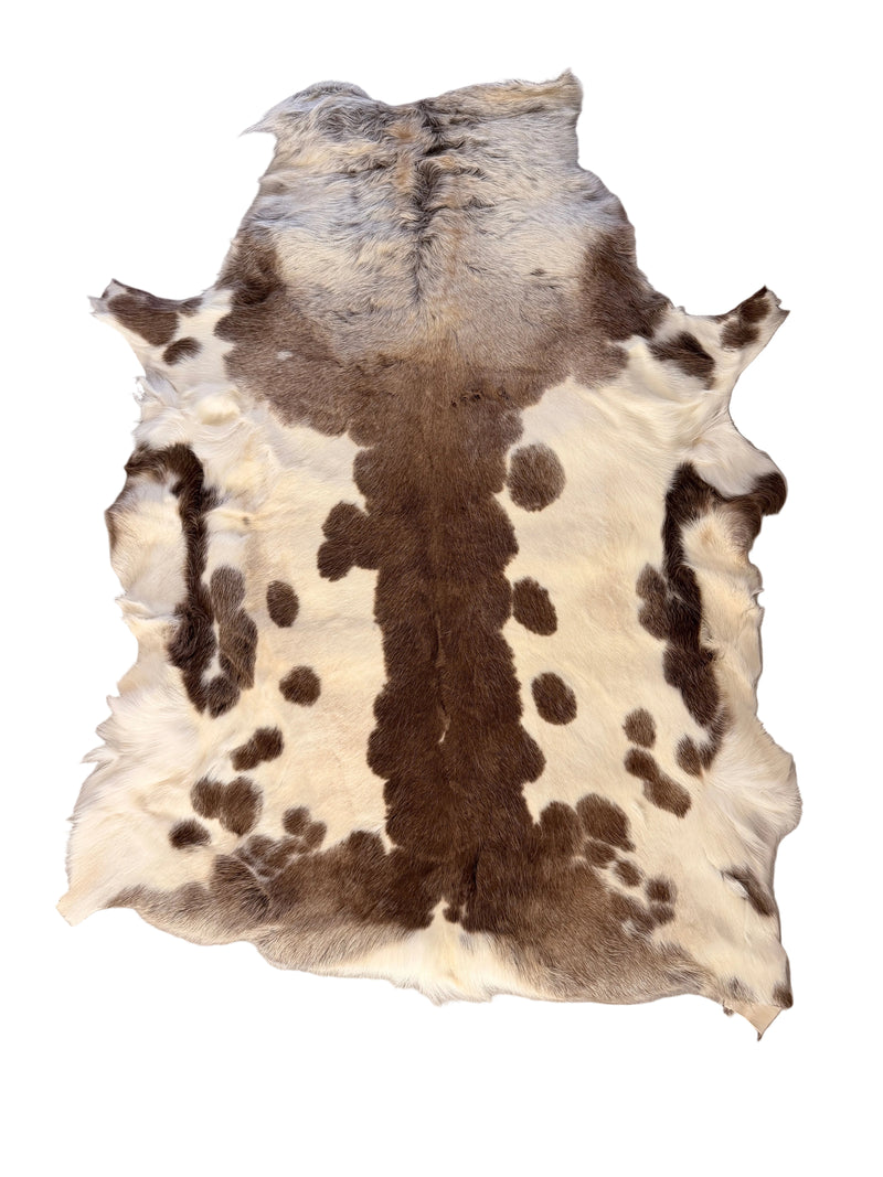 Reindeer outdoor quality hide with brown and white pattern on a gray floor