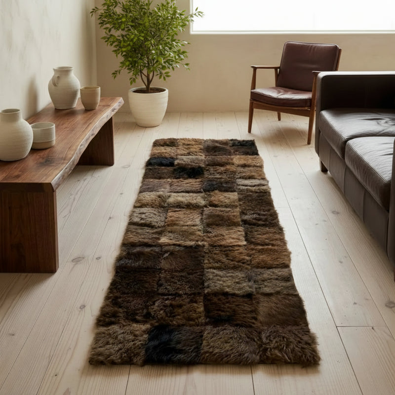 Long, checkered buffalo or bison area rug on a wooden floor with minimal decor.