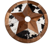 A circular cowhide Christmas tree skirt with brown and white patterns, featuring a star shape in the center and a visible zipper for attachment.