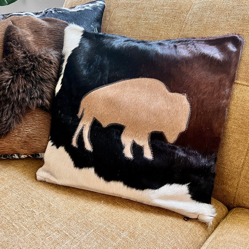 Decorative pillows with a buffalo design on a beige couch