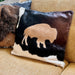 Decorative pillows with a buffalo design on a beige couch