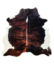 Brown brindle and black cowhide rug on a white background